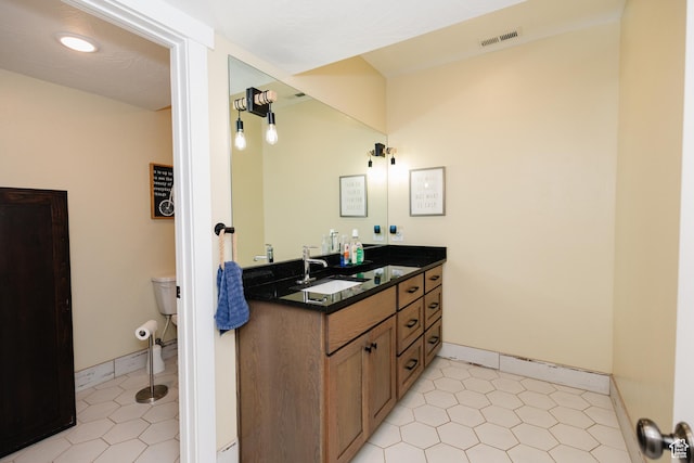 bathroom featuring vanity and toilet