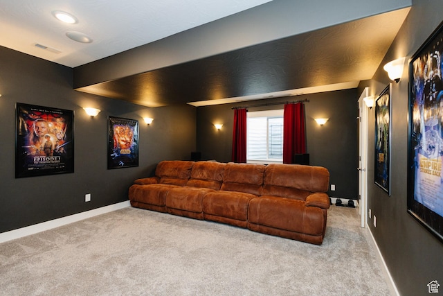 cinema room featuring light carpet