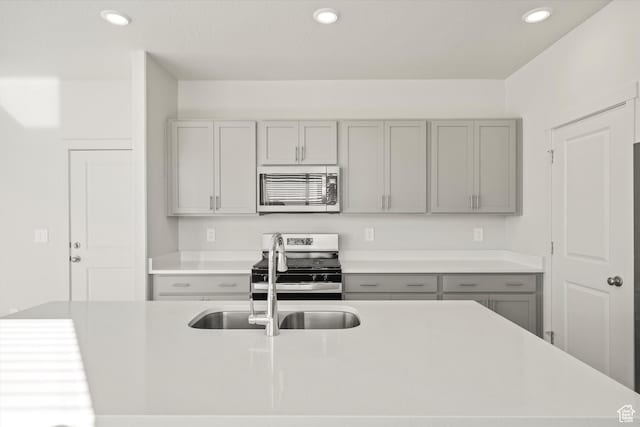 1367 N Harper Way Unit 0248, Tooele, UT 84074 - kitchen with stainless steel appliances, gray cabinetry, light countertops, and recessed lighting