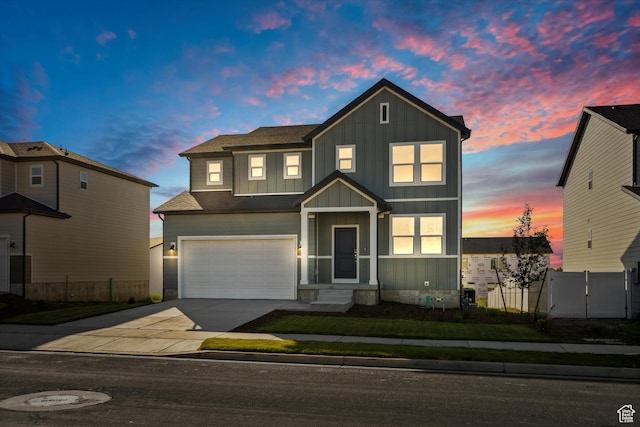 1367 N Harper Way Unit 0248, Tooele, UT 84074 - view of front of property featuring board and batten siding, concrete driveway, an attached garage, and a gate