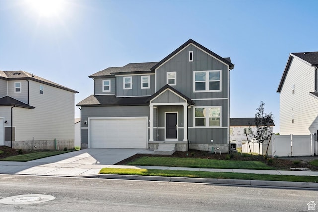 1367 N Harper Way Unit 0248, Tooele, UT 84074 - view of front of property featuring board and batten siding, driveway, a garage, and a gate