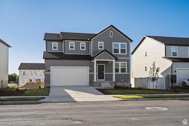 1367 N Harper Way Unit 0248, Tooele, UT 84074 - view of front of property with board and batten siding, an attached garage, and driveway