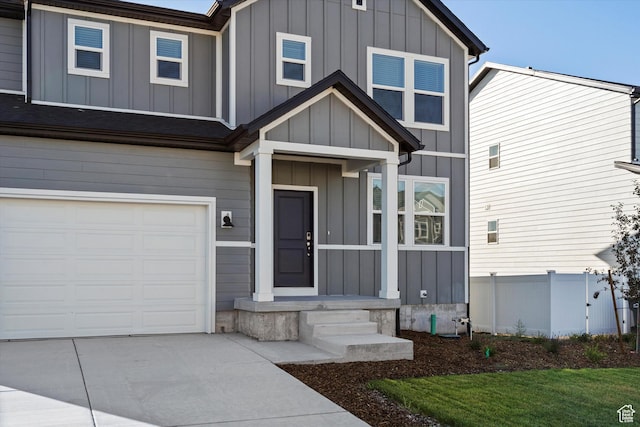 1367 N Harper Way Unit 0248, Tooele, UT 84074 - view of front of home featuring a garage, board and batten siding, and concrete driveway
