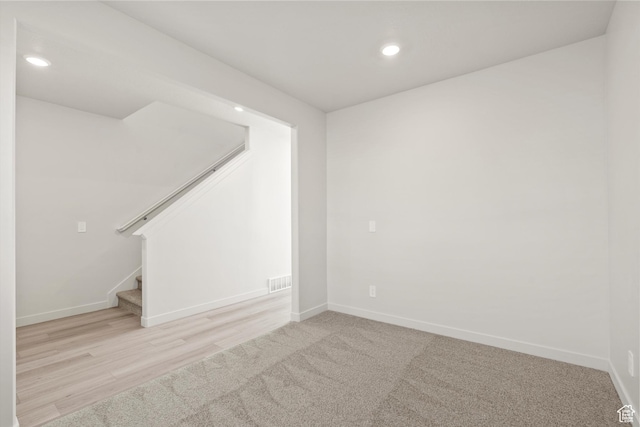 1367 N Harper Way Unit 0248, Tooele, UT 84074 - below grade area with recessed lighting, stairway, and wood finished floors