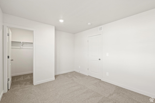 1367 N Harper Way Unit 0248, Tooele, UT 84074 - unfurnished bedroom with carpet flooring, a walk in closet, recessed lighting, and a closet