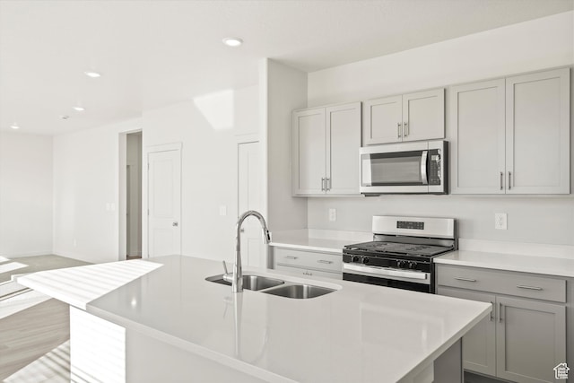 1367 N Harper Way Unit 0248, Tooele, UT 84074 - kitchen featuring stainless steel appliances, gray cabinetry, recessed lighting, light countertops, and an island with sink