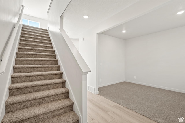 1367 N Harper Way Unit 0248, Tooele, UT 84074 - stairway with wood finished floors, recessed lighting, and carpet