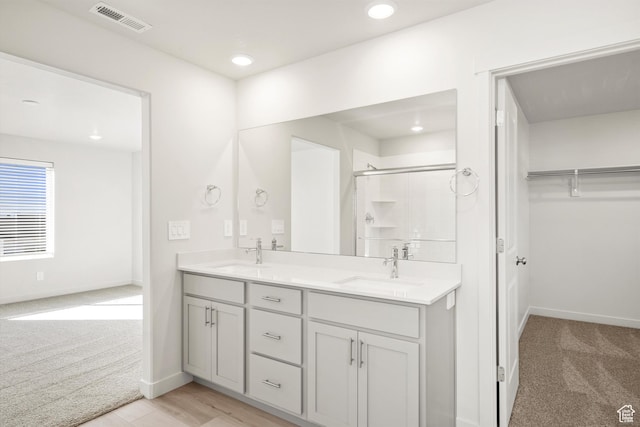 1367 N Harper Way Unit 0248, Tooele, UT 84074 - full bathroom featuring a stall shower, double vanity, a walk in closet, and recessed lighting