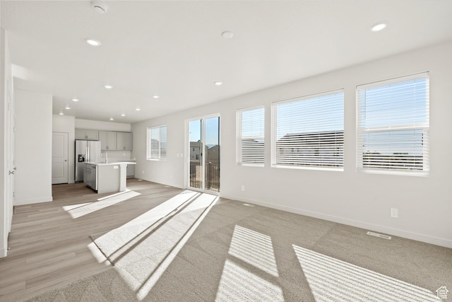 1367 N Harper Way Unit 0248, Tooele, UT 84074 - unfurnished living room featuring recessed lighting