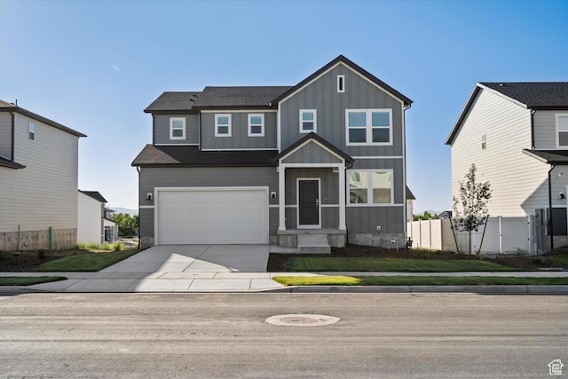 1367 N Harper Way Unit 0248, Tooele, UT 84074 - view of front of property featuring board and batten siding, driveway, and an attached garage