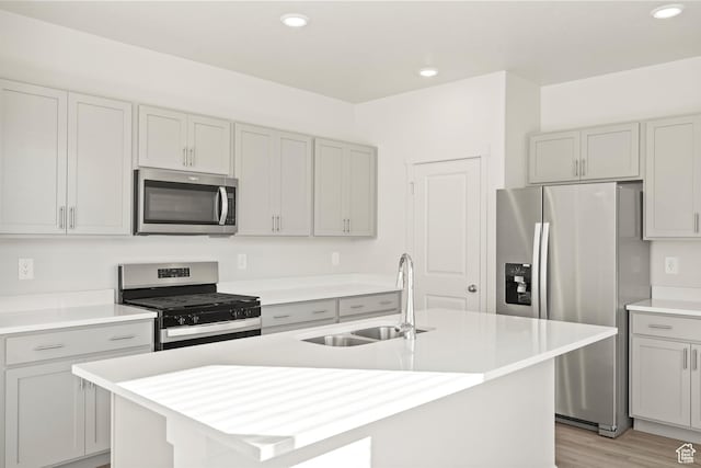1367 N Harper Way Unit 0248, Tooele, UT 84074 - kitchen featuring stainless steel appliances, light countertops, light wood finished floors, gray cabinets, and recessed lighting