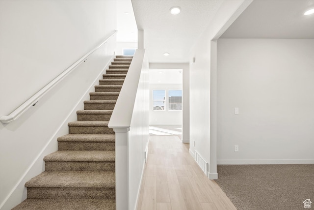 1367 N Harper Way Unit 0248, Tooele, UT 84074 - staircase featuring wood finished floors and recessed lighting