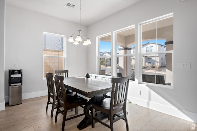 5629 S Adobe Sun Dr, St George, UT 84790 - dining area with light hardwood / wood-style floors and an inviting chandelier