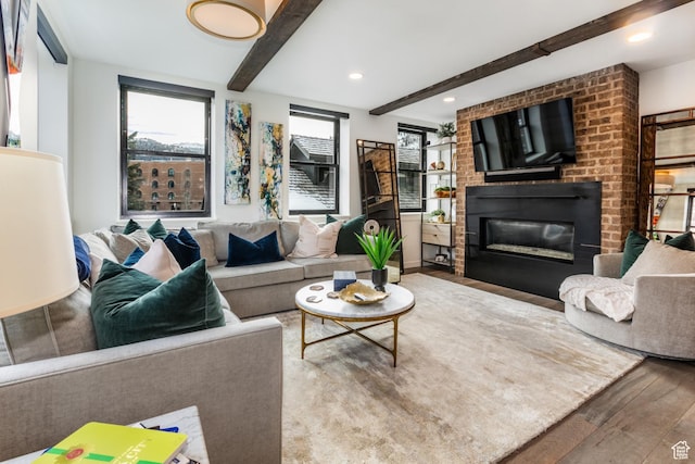 692 Main St Unit D, Park City, UT 84060 - living room featuring beam ceiling, a fireplace, and hardwood / wood-style floors