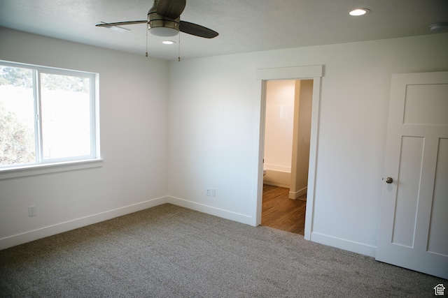 spare room featuring carpet and ceiling fan