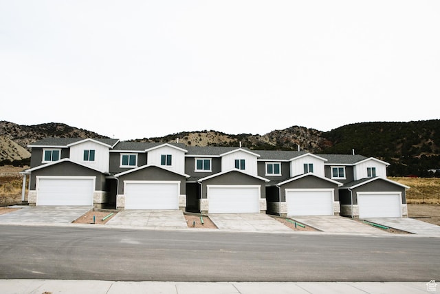 view of front of home with a mountain view and a garage