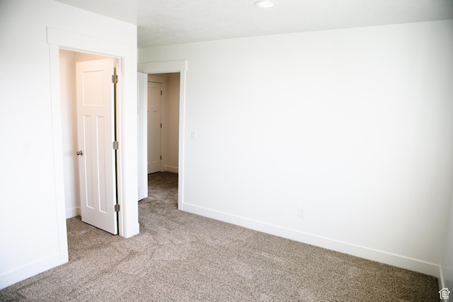 spare room with light colored carpet