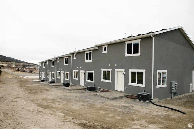 back of house featuring central AC unit