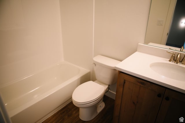 bathroom with hardwood / wood-style floors, vanity, and toilet