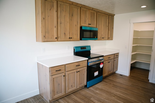 kitchen with electric range and dark wood-type flooring