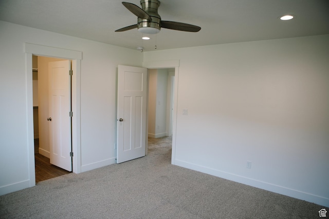 unfurnished bedroom with ceiling fan and carpet