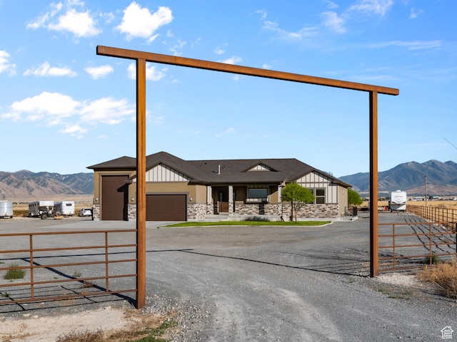 view of front facade featuring a mountain view and a garage