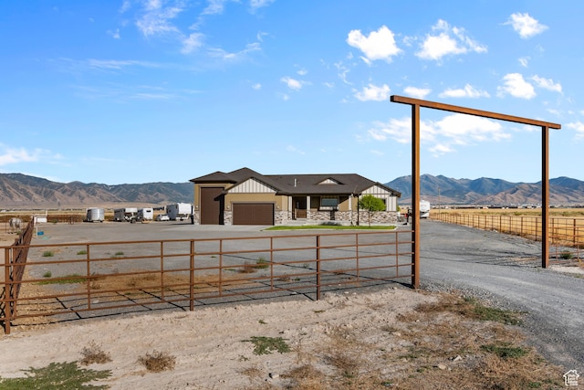 exterior space with a mountain view, a rural view, and a garage
