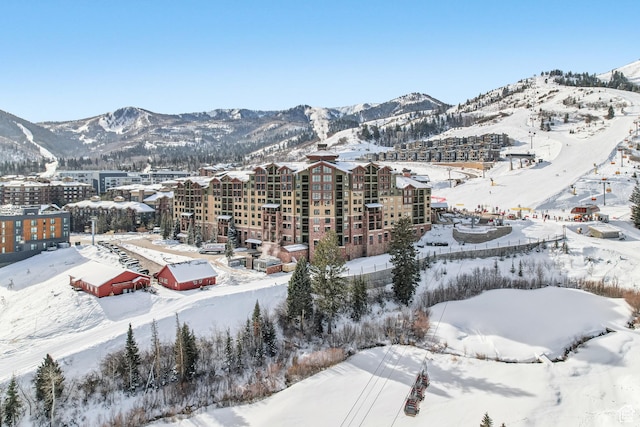 snowy aerial view with a mountain view