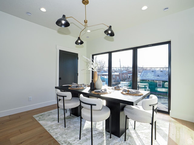 dining room with light wood-type flooring, baseboards, and recessed lighting