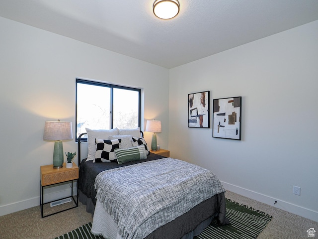 bedroom featuring carpet floors and baseboards