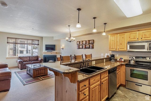 2669 Canyons Resort Dr Unit 308, Park City, UT 84098 - kitchen with sink, a breakfast bar area, decorative light fixtures, kitchen peninsula, and stainless steel appliances