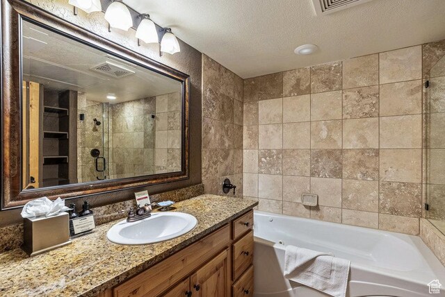 2669 Canyons Resort Dr Unit 308, Park City, UT 84098 - bathroom featuring separate shower and tub, vanity, and a textured ceiling