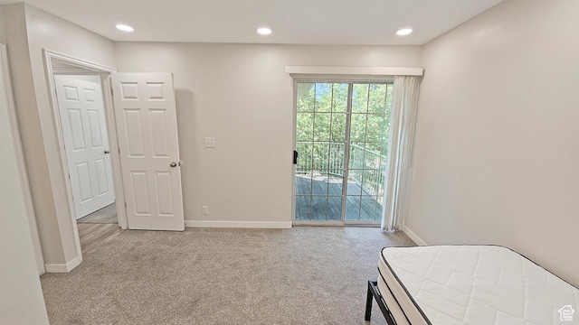 1303 N Riverside Ave Unit 36, Provo, UT 84604 - bedroom with light colored carpet, access to exterior, and recessed lighting