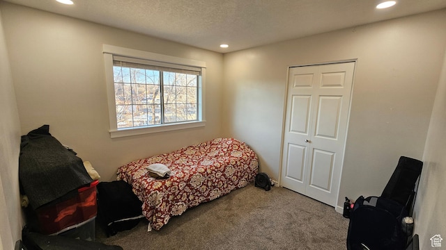 carpeted bedroom with a textured ceiling