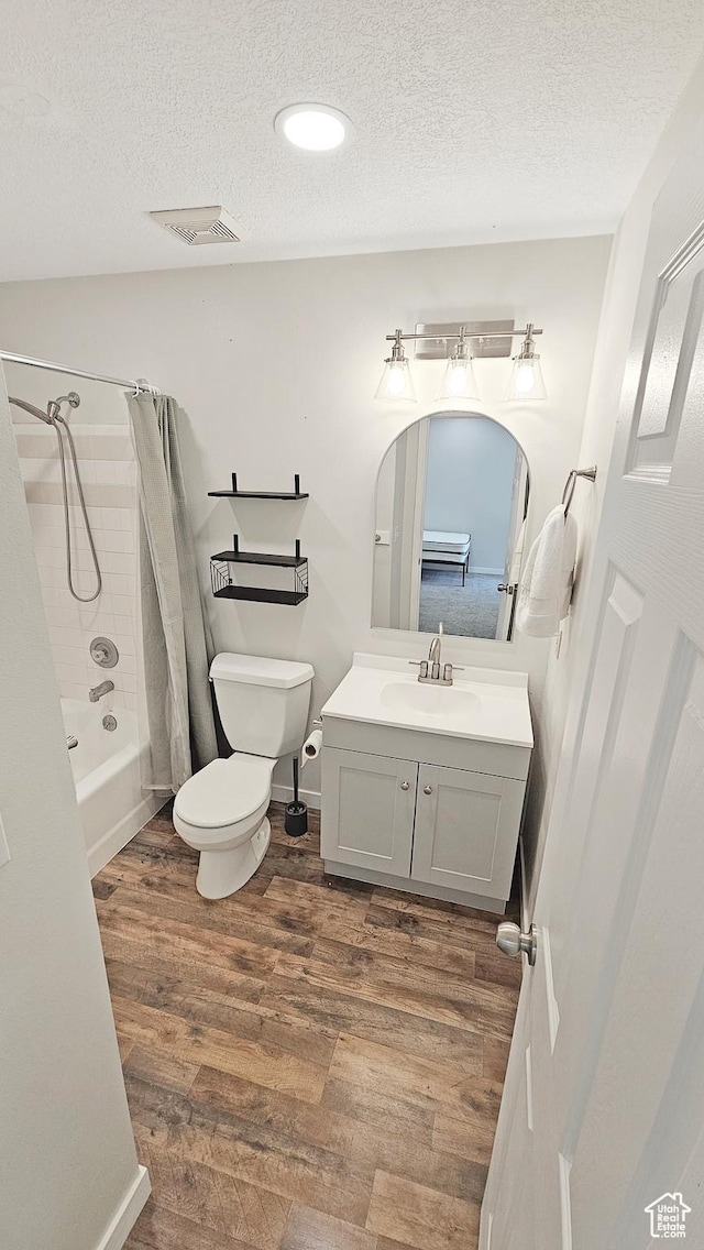 1303 N Riverside Ave Unit 36, Provo, UT 84604 - bathroom featuring wood finished floors, vanity, a textured ceiling, and shower / bath combination with curtain
