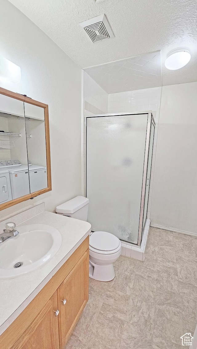 1303 N Riverside Ave Unit 36, Provo, UT 84604 - bathroom featuring washing machine and clothes dryer, vanity, a stall shower, and a textured ceiling