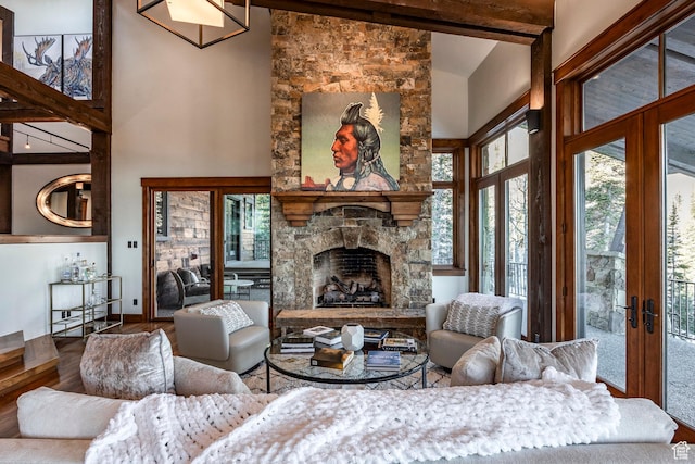 26 White Pine Canyon Rd, Park City, UT 84060 - living room featuring french doors, high vaulted ceiling, beamed ceiling, hardwood / wood-style floors, and a stone fireplace