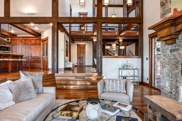 26 White Pine Canyon Rd, Park City, UT 84060 - living room with beam ceiling, a towering ceiling, and dark hardwood / wood-style floors