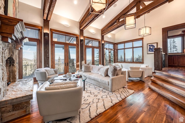 26 White Pine Canyon Rd, Park City, UT 84060 - living room featuring high vaulted ceiling, french doors, a stone fireplace, dark hardwood / wood-style floors, and beamed ceiling
