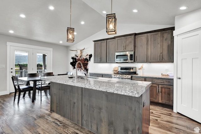 1021 N 600 E, Morgan, UT 84050 - kitchen featuring stainless steel appliances, wood finished floors, a sink, light stone counters, and lofted ceiling