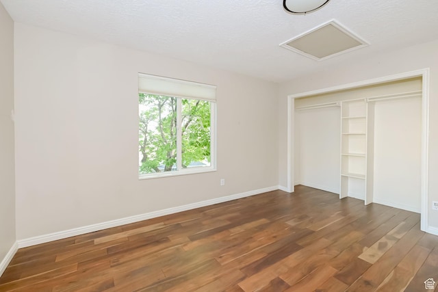 3568 N 500 E, North Ogden, UT 84414 - unfurnished bedroom featuring wood finished floors, baseboards, a closet, attic access, and a textured ceiling