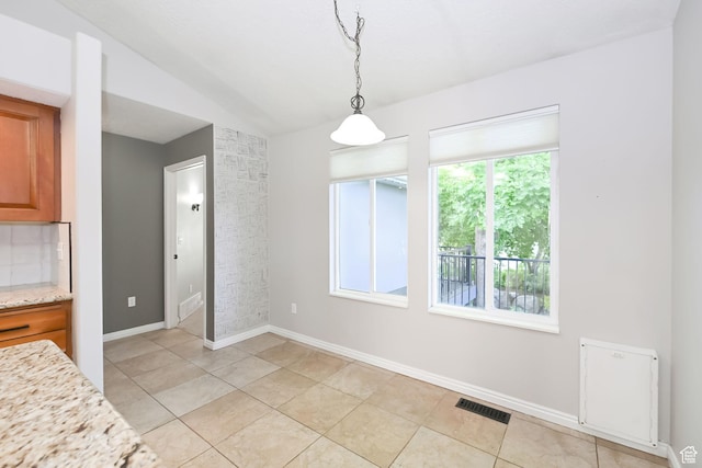 3568 N 500 E, North Ogden, UT 84414 - unfurnished dining area featuring light tile patterned floors, vaulted ceiling, and baseboards