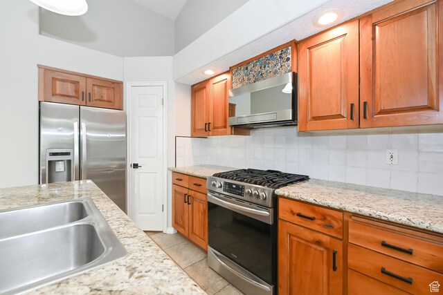 3568 N 500 E, North Ogden, UT 84414 - kitchen with stainless steel appliances, decorative backsplash, a sink, and brown cabinetry