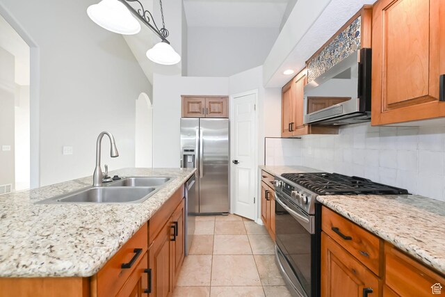 3568 N 500 E, North Ogden, UT 84414 - kitchen with stainless steel appliances, a sink, tasteful backsplash, pendant lighting, and brown cabinets