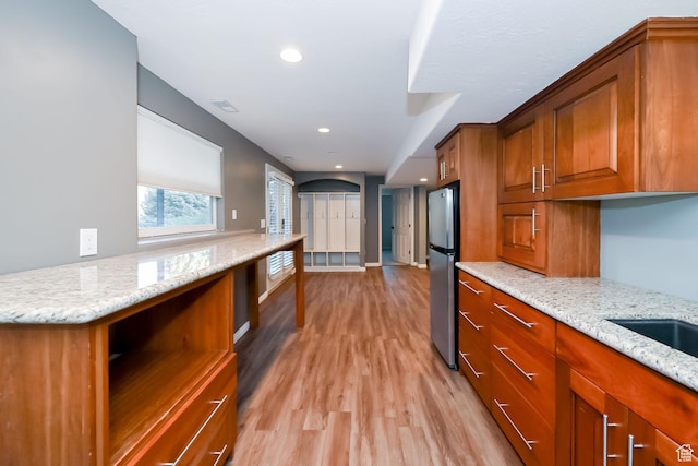 3568 N 500 E, North Ogden, UT 84414 - kitchen featuring freestanding refrigerator, brown cabinets, light wood finished floors, light stone counters, and recessed lighting