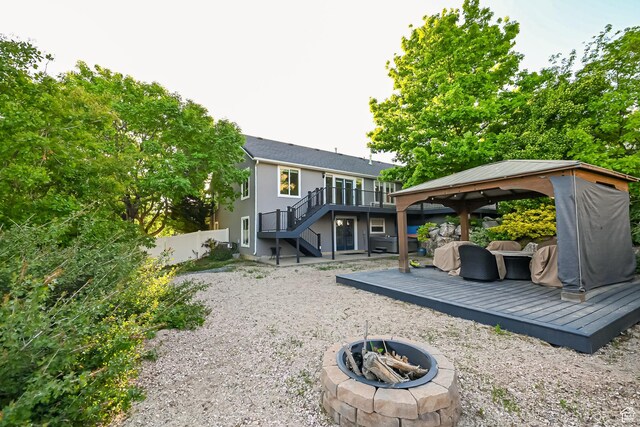 3568 N 500 E, North Ogden, UT 84414 - rear view of house with a fire pit, a gazebo, stairway, a wooden deck, and fence