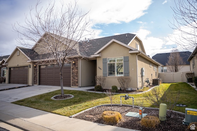 ranch-style house with central air condition unit, a front yard, and a garage