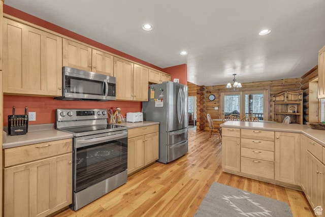 4125 S Buck Way Unit 1958, Heber City, UT 84032 - kitchen with log walls, stainless steel appliances, light hardwood / wood-style flooring, a chandelier, and decorative light fixtures
