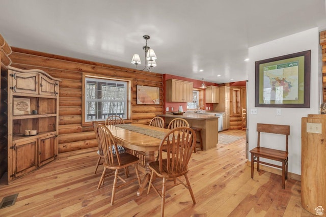 4125 S Buck Way Unit 1958, Heber City, UT 84032 - dining area with light hardwood / wood-style flooring, a healthy amount of sunlight, rustic walls, and a chandelier