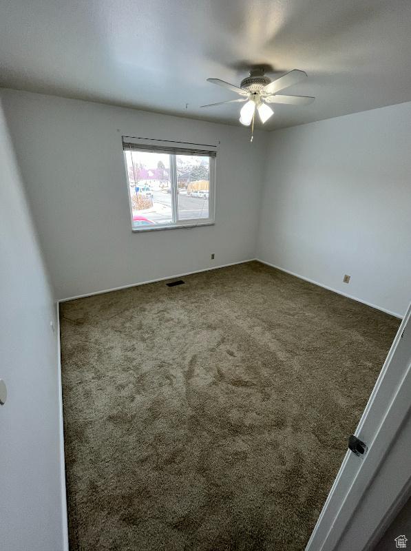 carpeted empty room with ceiling fan